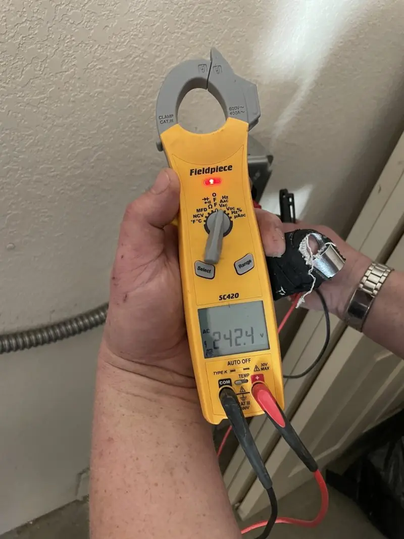 Voltage testing with clamp meter during Recessed Lighting Installation in Clinton